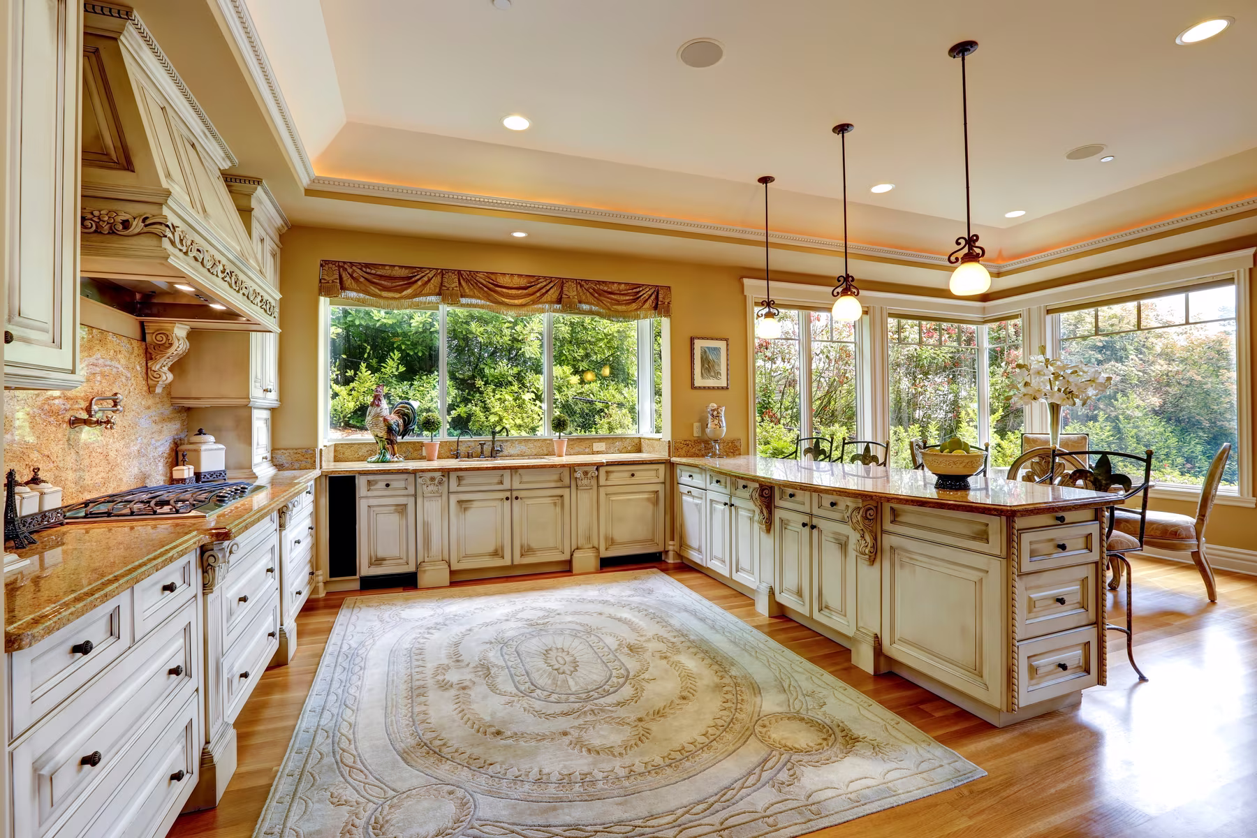 Large decorative area rug in a spacious kitchen with hardwood floors and custom cabinetry.