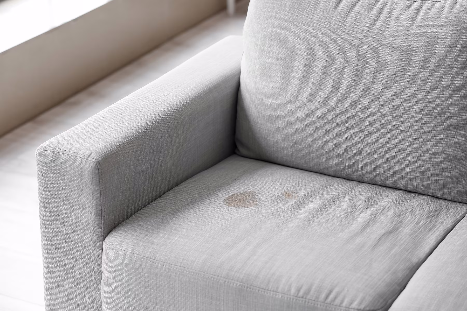light-gray-armchair-with-upholstery-stain
