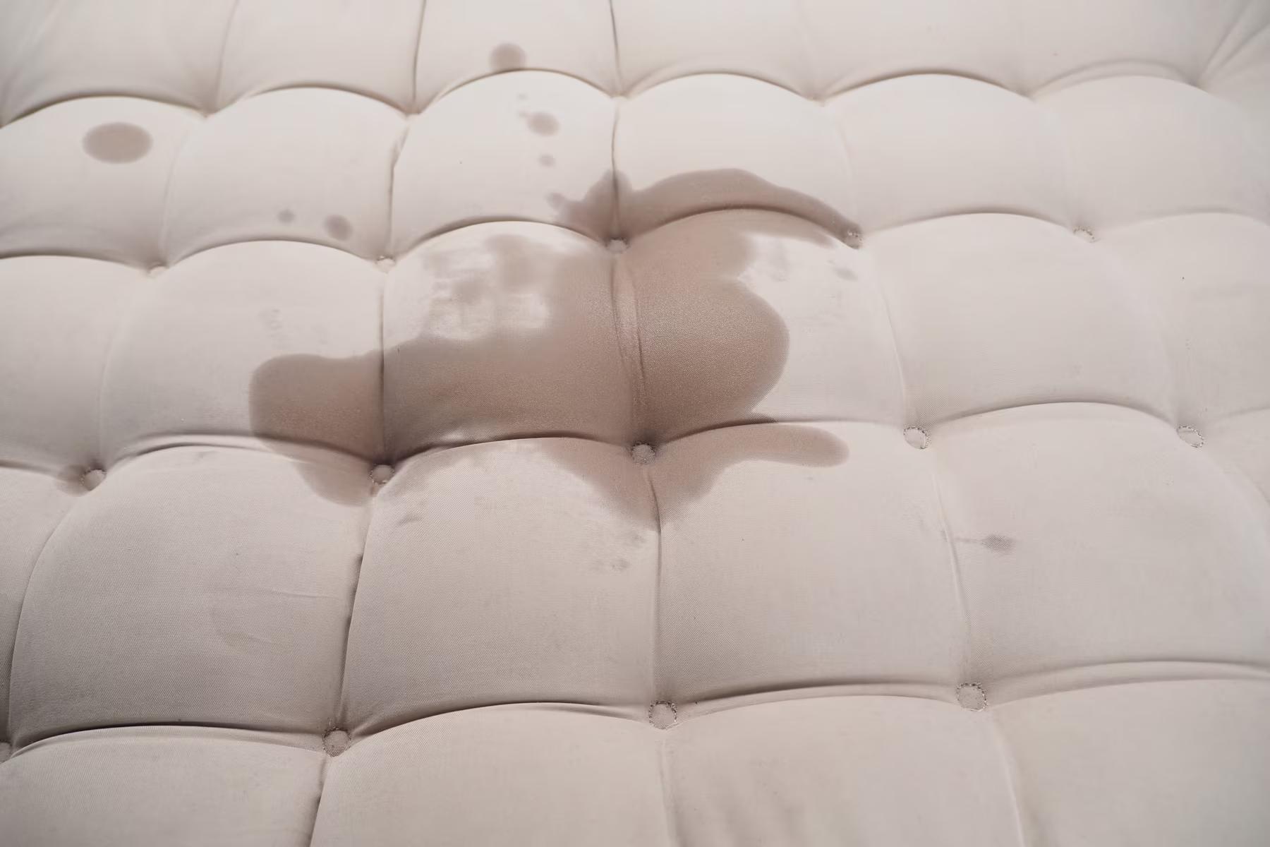 spilled-liquid-on-tufted-ottoman